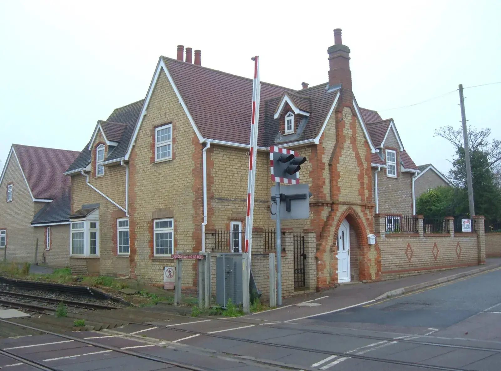 The old brick station building beside the level crossing at Lidlington